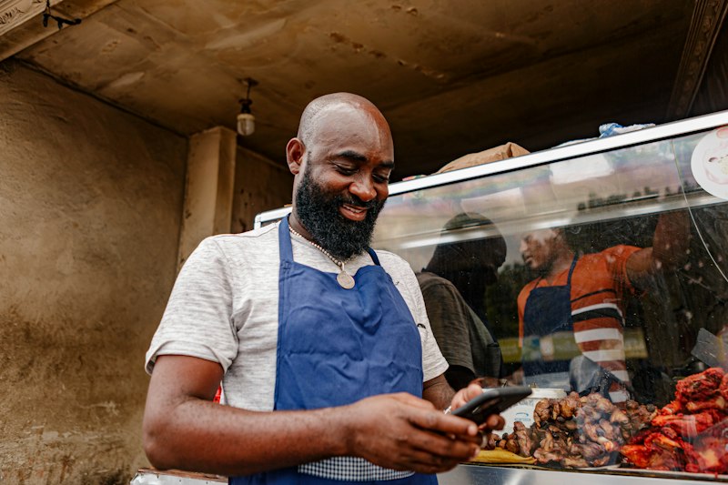 Business owner checking orders on his phone