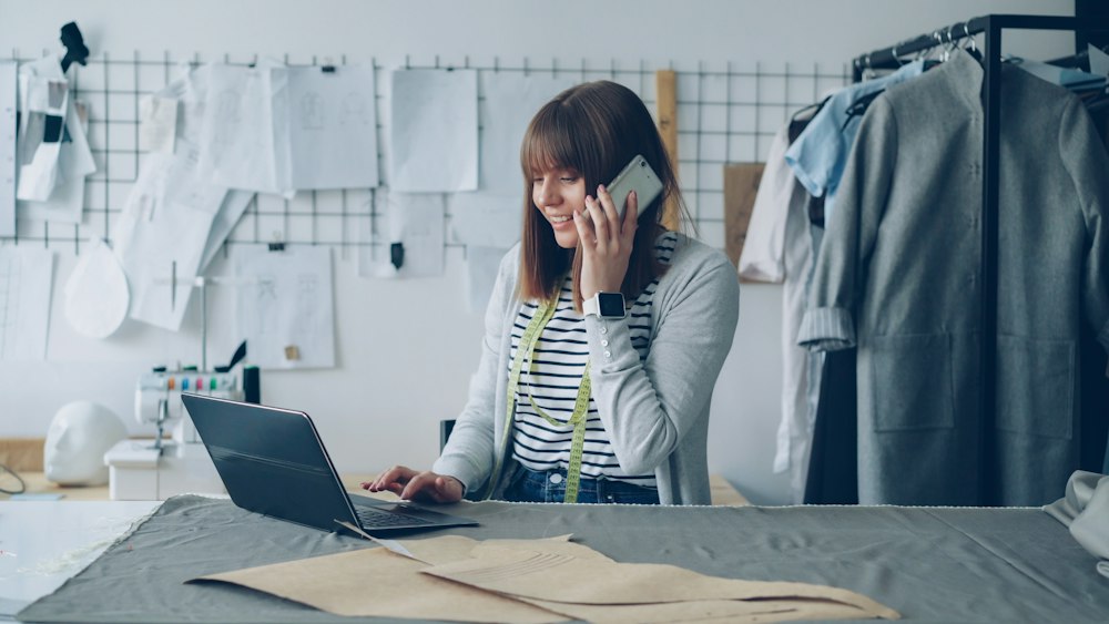 Designer on the phone with a laptop